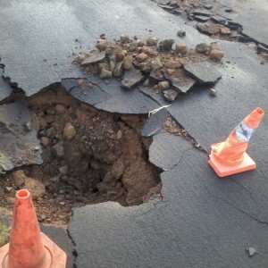 A very deep hole in the road
